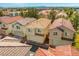 Aerial view of neighborhood with townhouses featuring red tile roofs and well-maintained exteriors at 3023 Sunrise Bay Ave, North Las Vegas, NV 89031