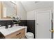 Stylish half bathroom featuring dark wood accent paneling, white quartz countertop, and a modern black faucet at 3023 Sunrise Bay Ave, North Las Vegas, NV 89031