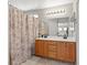 Functional bathroom with double sink vanity, decorative shower curtain, and neutral color scheme at 3023 Sunrise Bay Ave, North Las Vegas, NV 89031