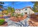Well-maintained landscaping and walking paths enhance the curb appeal of these charming townhomes at 3023 Sunrise Bay Ave, North Las Vegas, NV 89031
