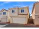 Townhouse exterior with a large garage, showcasing the red tile roof and private yard at 3023 Sunrise Bay Ave, North Las Vegas, NV 89031