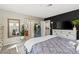 Bright main bedroom featuring modern decor, large window, and en-suite bathroom access at 3023 Sunrise Bay Ave, North Las Vegas, NV 89031