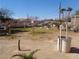 Expansive backyard with sparse landscaping, mature trees, and a clear view of the blue sky above at 3127 Aloha Ave, Las Vegas, NV 89121