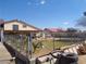 Backyard with mature landscaping, fencing, and a view of the home's exterior under a bright, sunny sky at 3127 Aloha Ave, Las Vegas, NV 89121