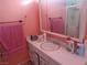This pink bathroom has a sink, mirror, shower and colorful towels at 3127 Aloha Ave, Las Vegas, NV 89121