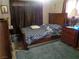 This bedroom has neutral carpeting, a bed, and a window covered by curtains at 3127 Aloha Ave, Las Vegas, NV 89121