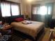 This bedroom has neutral carpeting, a bed and a window covered by curtains at 3127 Aloha Ave, Las Vegas, NV 89121