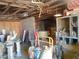 Open garage featuring exposed wooden beams, filled with an eclectic mix of tools and materials ready for your next project at 3127 Aloha Ave, Las Vegas, NV 89121