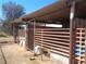 This exterior shows horse stalls with metal gating over concrete bottoms with a sandy ground area at 3127 Aloha Ave, Las Vegas, NV 89121
