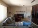Comfortable living room with a large sofa, fireplace, and ample space for relaxation at 3127 Aloha Ave, Las Vegas, NV 89121