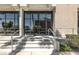 Inviting building entrance with stone steps, modern architecture, and lush greenery at 353 E Bonneville Ave # 183/283, Las Vegas, NV 89101