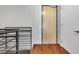 Clean hallway featuring modern railing, wood flooring, and neutral tones for a minimalist aesthetic at 353 E Bonneville Ave # 183/283, Las Vegas, NV 89101