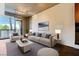 Elegant living room featuring a light color palette, comfortable seating, and plenty of natural light from the balcony at 353 E Bonneville Ave # 183/283, Las Vegas, NV 89101