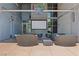 Relaxing outdoor patio area with comfortable lounge seating and a large screen for entertainment at 353 E Bonneville Ave # 183/283, Las Vegas, NV 89101