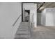 Industrial-style staircase showcasing raw concrete, metal railings, and an open design, leads to an additional floor at 353 E Bonneville Ave # 183/283, Las Vegas, NV 89101