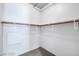 A walk-in closet with white walls and wooden clothing racks for optimal organization at 353 E Bonneville Ave # 375, Las Vegas, NV 89101