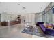 Modern condo lobby with front desk and lounge area with purple sofa and floor to ceiling windows at 353 E Bonneville Ave # 375, Las Vegas, NV 89101