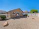 A spacious backyard with gravel, brick patio, and a white fence, perfect for outdoor activities and relaxation at 4016 Balsam Mountain St, Las Vegas, NV 89129