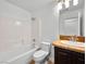 Bathroom featuring a shower-tub combo, toilet, sink with vanity, and wood-look floors at 4016 Balsam Mountain St, Las Vegas, NV 89129