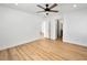 Large bedroom with wood-look floors, ceiling fan, and en-suite bathroom with closet at 4016 Balsam Mountain St, Las Vegas, NV 89129