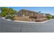 A corner lot home is terraced with gravel and minimal desert foliage for low maintenance at 4016 Balsam Mountain St, Las Vegas, NV 89129