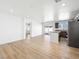 Open-concept kitchen view showing stainless appliances, island, and sliding glass doors to back at 4016 Balsam Mountain St, Las Vegas, NV 89129