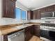 Gourmet kitchen featuring stainless steel appliances, granite counters, and dark cabinets at 4016 Balsam Mountain St, Las Vegas, NV 89129