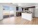 Bright kitchen featuring stainless appliances, brown cabinets, and sliding glass doors to back yard at 4016 Balsam Mountain St, Las Vegas, NV 89129