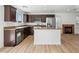 Contemporary kitchen featuring stainless appliances, granite countertops, and dark wood cabinets at 4016 Balsam Mountain St, Las Vegas, NV 89129