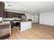 Open concept kitchen with stainless appliances, dark wood cabinets, and an island at 4016 Balsam Mountain St, Las Vegas, NV 89129