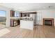 Open floor plan with wood floors, stainless appliances and dark wood kitchen cabinets at 4016 Balsam Mountain St, Las Vegas, NV 89129