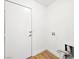Laundry room area with exterior door access, hookups for washer and dryer, and wood-look floors at 4016 Balsam Mountain St, Las Vegas, NV 89129