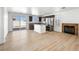 Open concept living space with wood floor, fireplace, and stainless steel appliances at 4016 Balsam Mountain St, Las Vegas, NV 89129