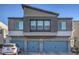 Modern two-story home showcasing a gray exterior, three-car garage, and a small balcony with iron railing at 4278 Lemay St # 2, Las Vegas, NV 89115