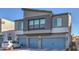 Modern two-story home showcasing a gray exterior and a three-car garage with driveway at 4278 Lemay St # 2, Las Vegas, NV 89115