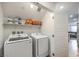 A practical laundry room with modern appliances and ample shelving for storage at 4278 Lemay St # 2, Las Vegas, NV 89115