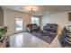 Bright living room featuring tile floors, modern sofas, and a sliding glass door to the backyard at 4278 Lemay St # 2, Las Vegas, NV 89115