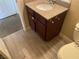 Bathroom with dark wood vanity and laminate floors at 4370 Sandy River Dr # 24, Las Vegas, NV 89103