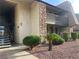 Condo exterior showcasing a covered patio, stacked stone accents, and tidy, mature greenery at 4370 Sandy River Dr # 24, Las Vegas, NV 89103
