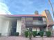 Inviting condo complex featuring stone accents, a red tile roof and well-maintained landscaping at 4370 Sandy River Dr # 24, Las Vegas, NV 89103