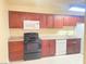 Well-equipped kitchen featuring wood cabinets, laminate countertops and essential appliances at 4370 Sandy River Dr # 24, Las Vegas, NV 89103