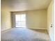Large living room showcasing neutral walls, carpet, balcony access, and a bright open feel at 4370 Sandy River Dr # 24, Las Vegas, NV 89103