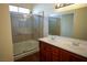 Bright bathroom features a glass-enclosed shower and double sink vanity with wood cabinets at 5200 Brookmere Dr, Las Vegas, NV 89130