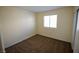 This carpeted bedroom has a window that allows plenty of natural light to fill the room at 5200 Brookmere Dr, Las Vegas, NV 89130