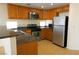 Bright kitchen with stainless steel appliances, stone countertops, and oak wood cabinets at 5200 Brookmere Dr, Las Vegas, NV 89130