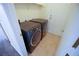 Bright laundry room with side-by-side washer and dryer setup for efficient laundry tasks at 5200 Brookmere Dr, Las Vegas, NV 89130