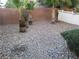 Low-maintenance backyard featuring decorative rock cover and desert landscaping at 5481 Railroad River Ave, Las Vegas, NV 89139