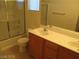 Bathroom featuring double sink vanity with wood cabinets and a shower-tub combo at 5481 Railroad River Ave, Las Vegas, NV 89139