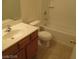 Bathroom boasts a single sink vanity, a neutral color scheme and a bathtub with shower at 5481 Railroad River Ave, Las Vegas, NV 89139