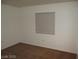 Neutral bedroom showcases hardwood floors and a single window letting in ample sunlight at 5481 Railroad River Ave, Las Vegas, NV 89139